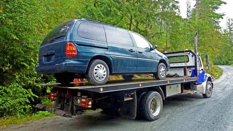 Baltimore flatbed towing a cargo van